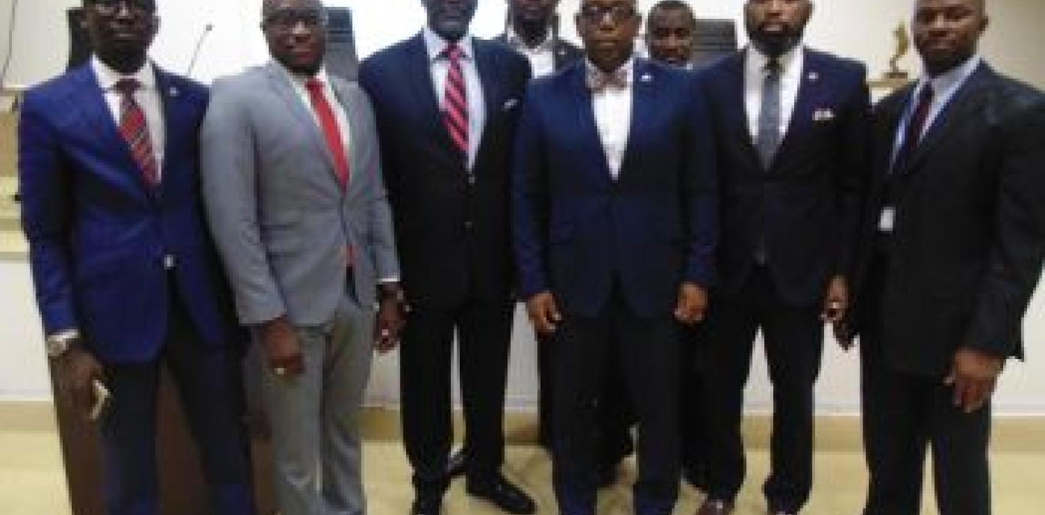 Dr. Siaplay (center), with insurance executives