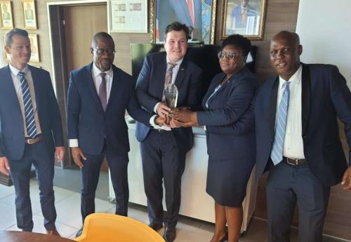 CBL Executive Governor J. Aloysius Tarlue, Jr. (second from left) receives the award from Messrs. Ulrich Rebele, Regional Sales Director of G+D and Alexander Huber, Product Manager for Security Threads of G +D.