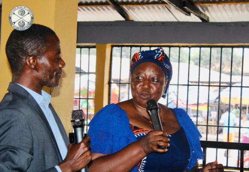 Cllr. Zeon, head of CBL Communications Section, shares information with a Market Superintendent 
